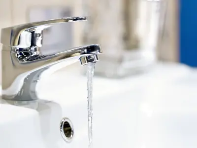 bathroom sink and faucet with water running