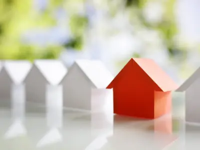 row of houses with one appearing in red