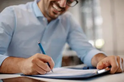 man signing contract