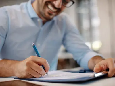 man signing contract