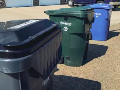 grey green and blue waste collection bins