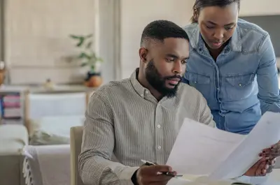 Two people discussing their bill.