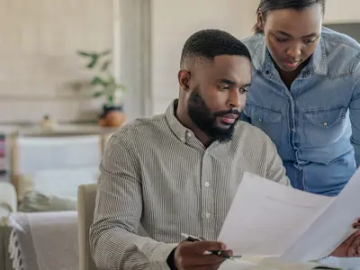 Two people discussing their bill.