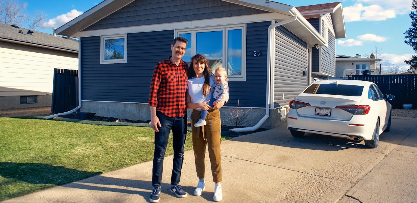 handsome family in front of home