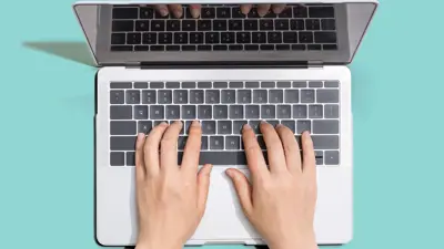 hands typing on laptop computer