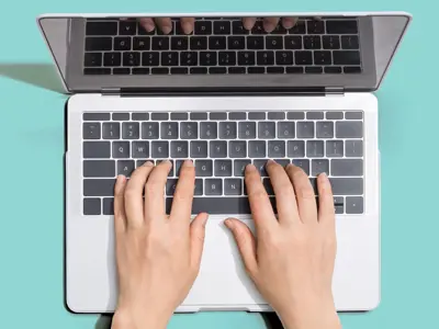 hands typing on laptop computer