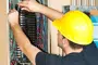 alt="Electrician working on electrical panel"