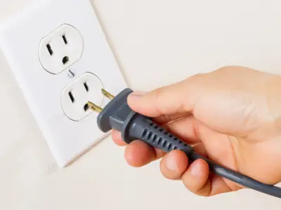 a cord being plugged into an electrical outlet