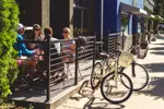 alt="Residents having lunch on an outdoor patio downtown"
