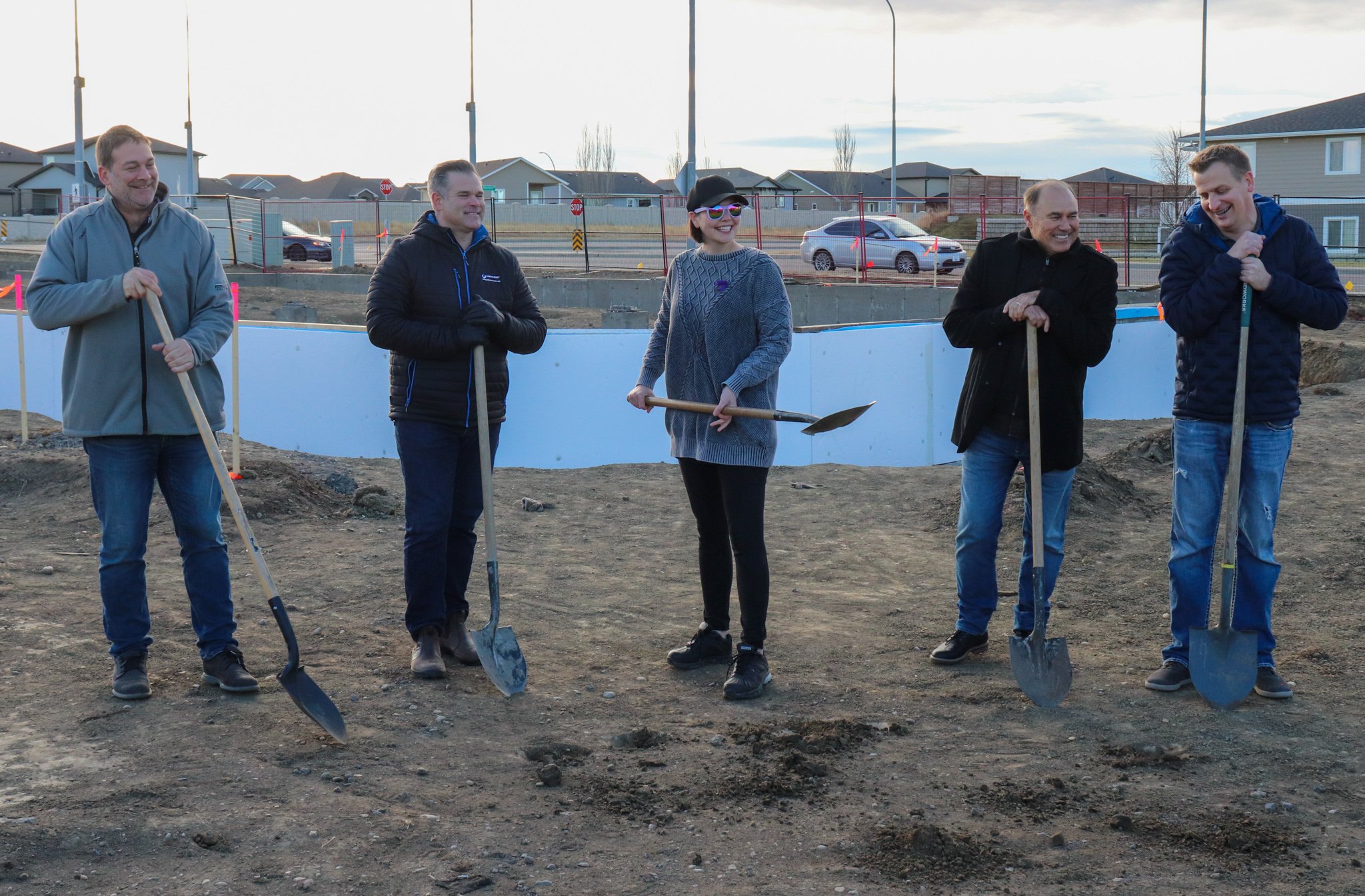 Representatives of Invest Medicine Hat, Mid-West, DAAS Developers, Mayor Linnsie Clark, and Matthew Gibbs, break ground at Southlands Commons.